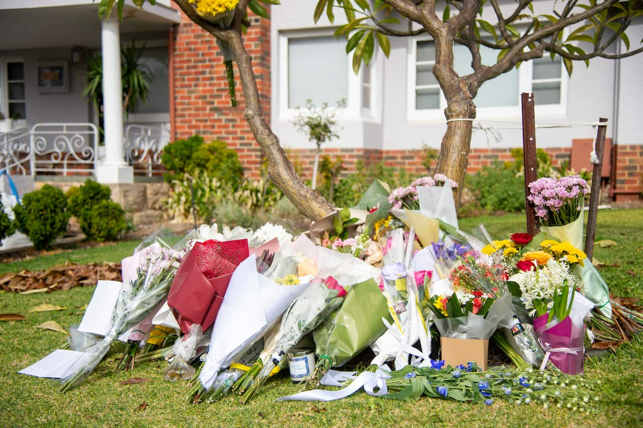 Floral tributes seen outside a home. 