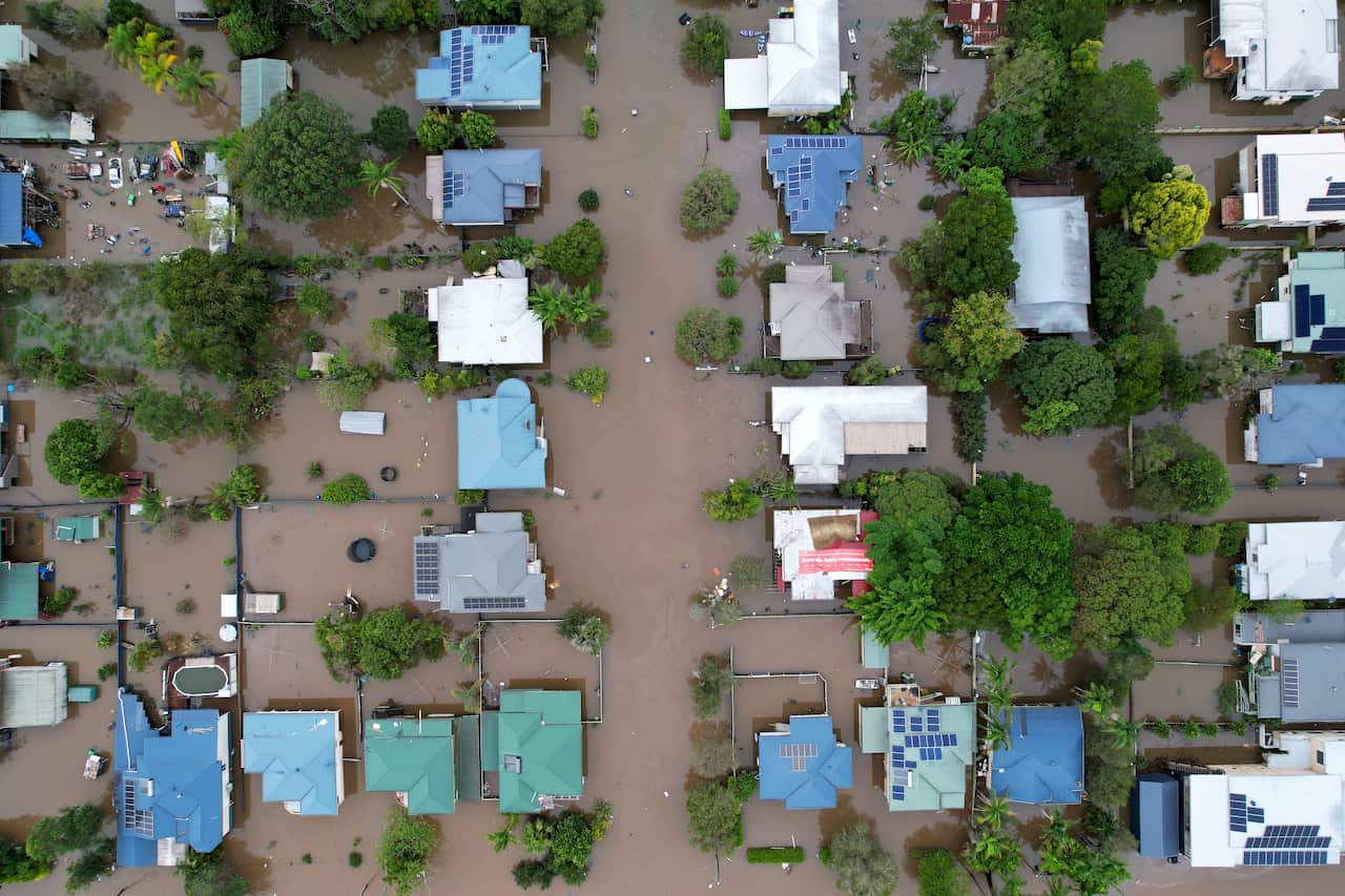 Houses are seen surrounded by floodwater in an aerial photo.