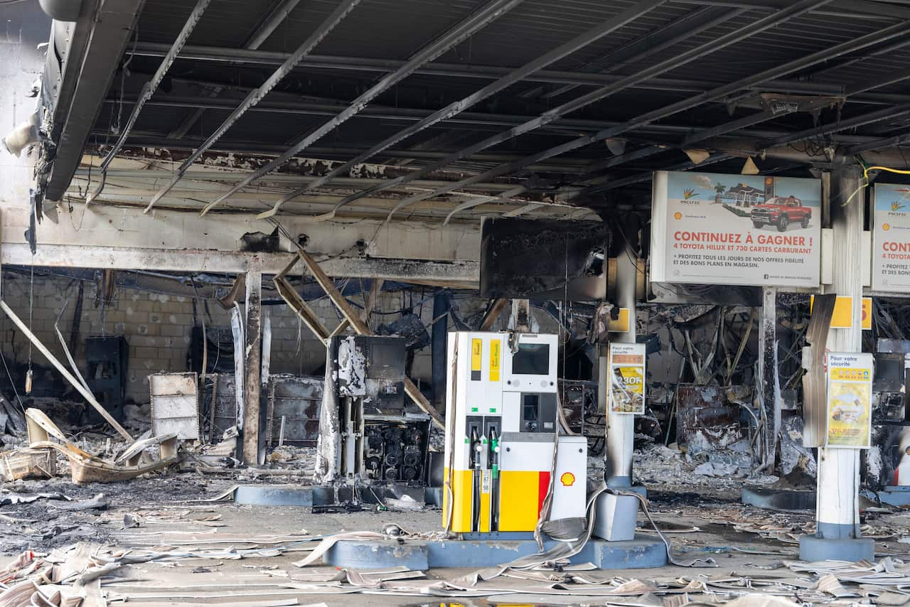 Remnants of a gas station burned by rioters