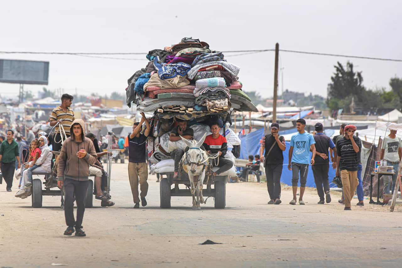 Palestinians moving their belongings using a donkey cart