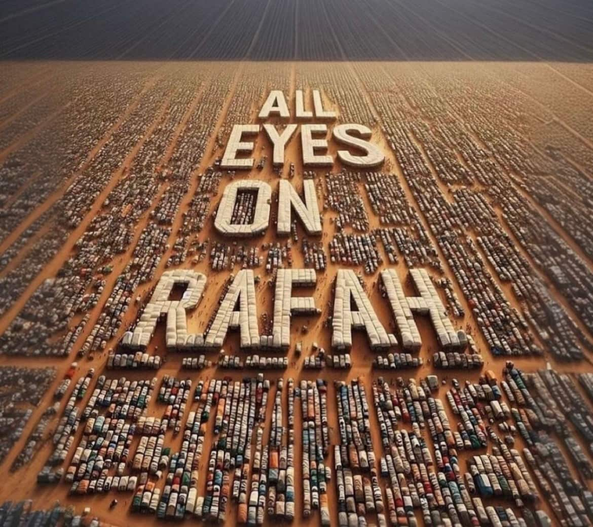 Tents in a camp arranged to spell out the phrase "All Eyes on Rafah" against a desert backdrop