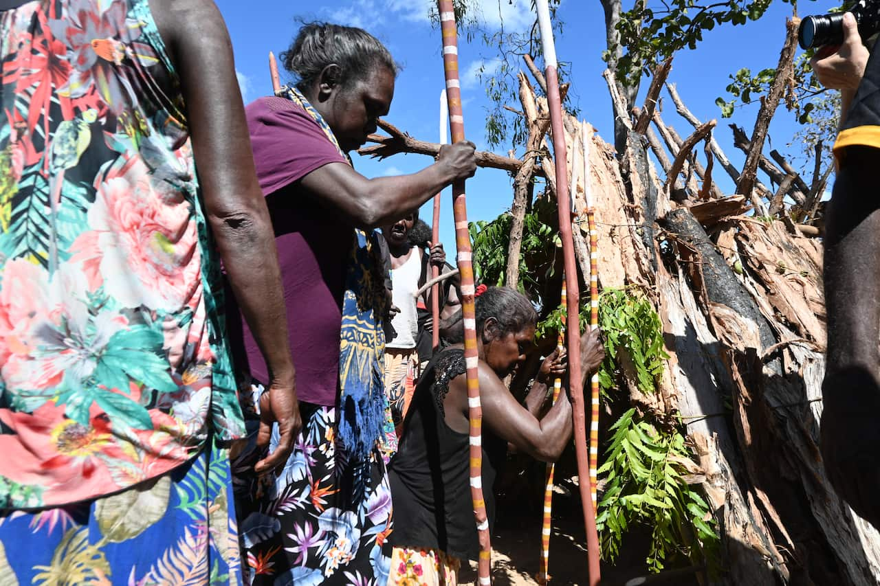 Women dance around an old birthing hut in an important ceremony in Galiwin'ku