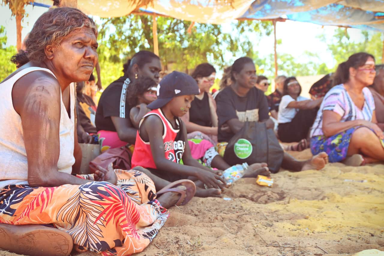 The community gathers to listen to elders at a ceremony on birthing in Galiwin'ku