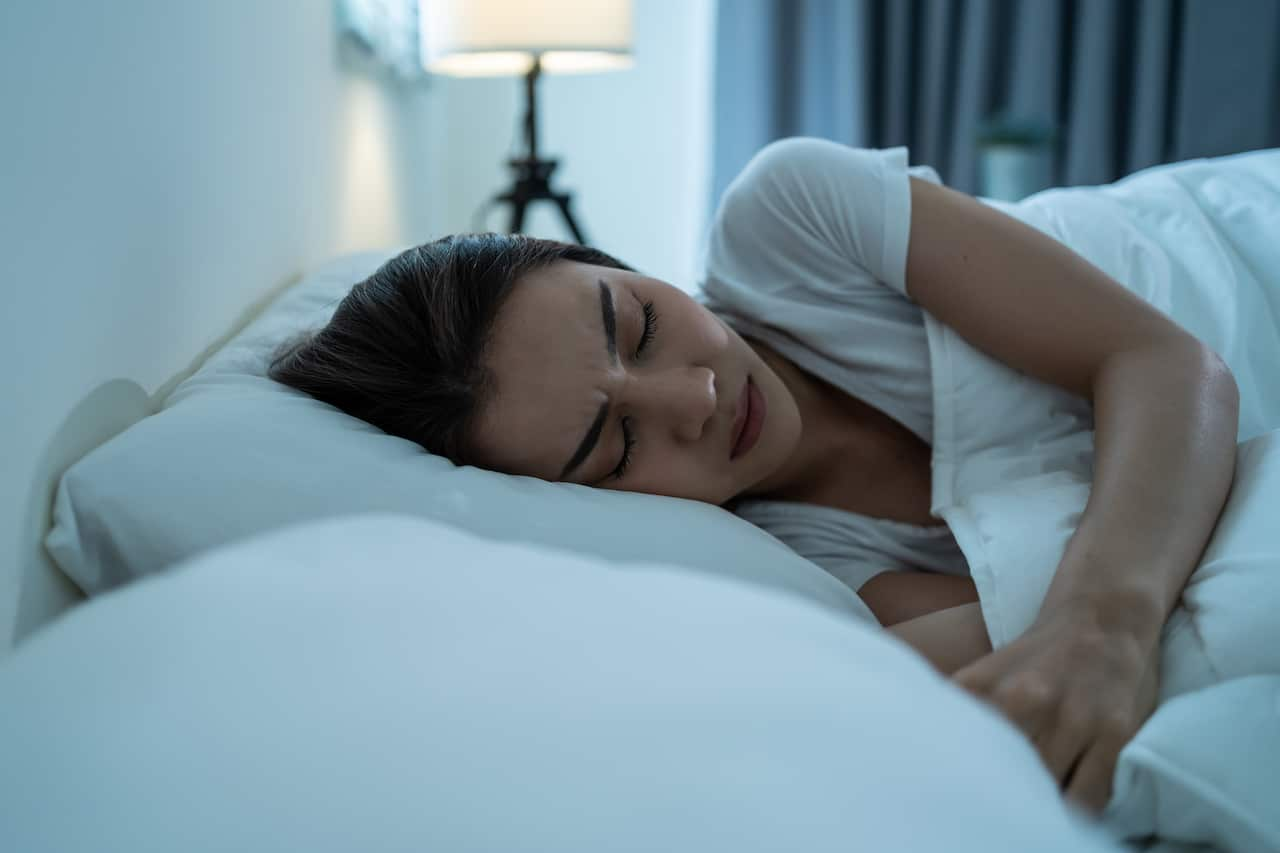 A woman asleep in bed.