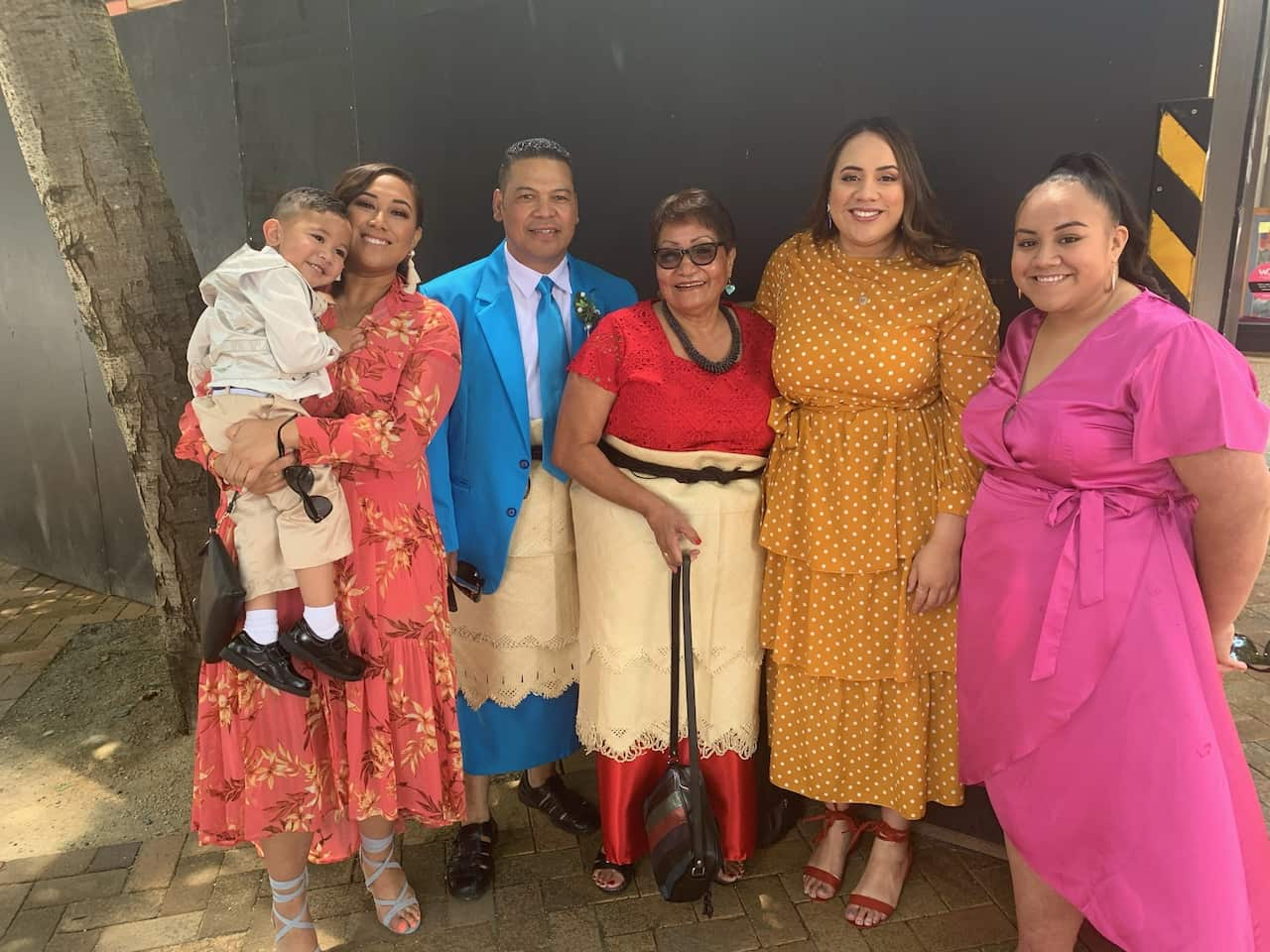 Members of a family smile for a photo. 