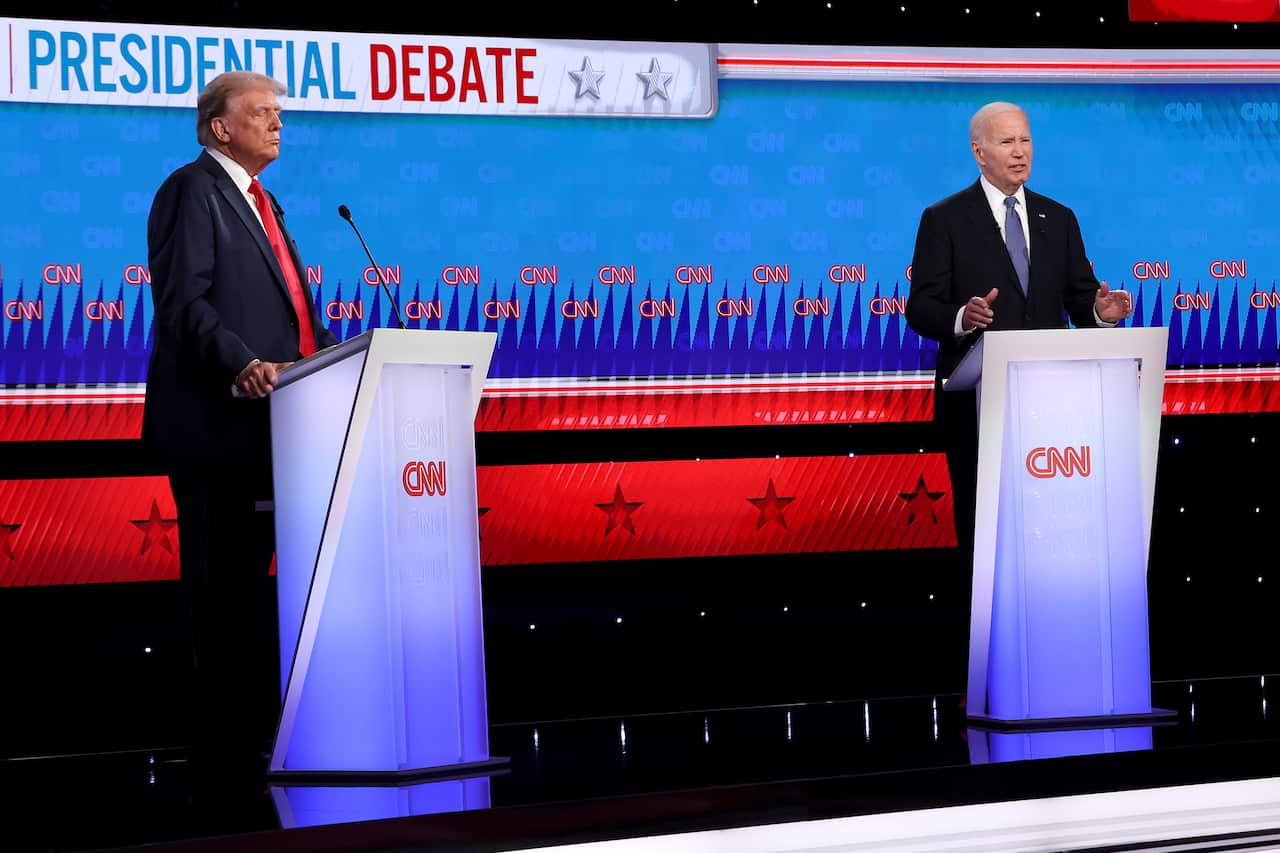 Donald Trump and Joe Biden standing at opposite podiums.