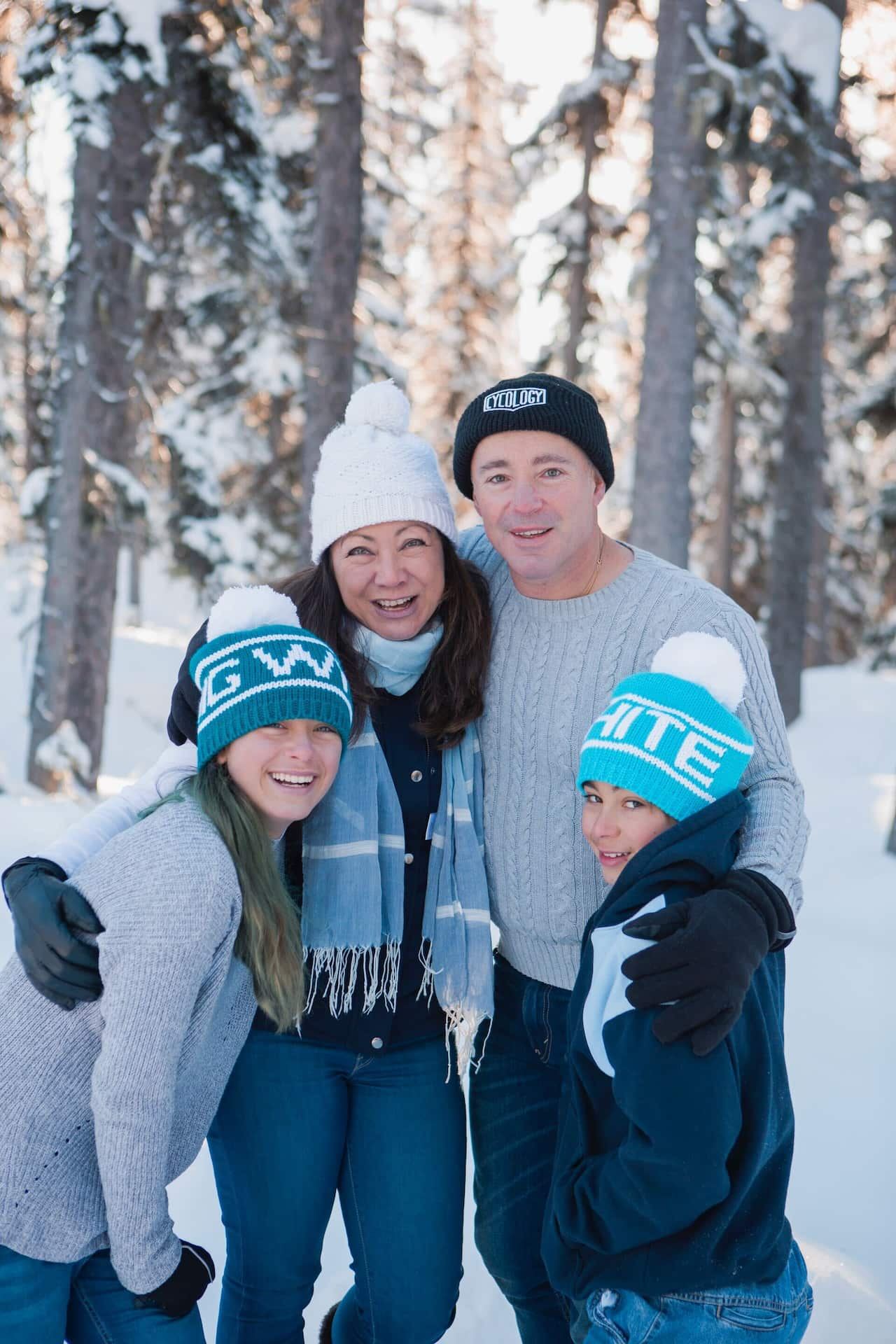 A family poses for a photo in a snowy landscape