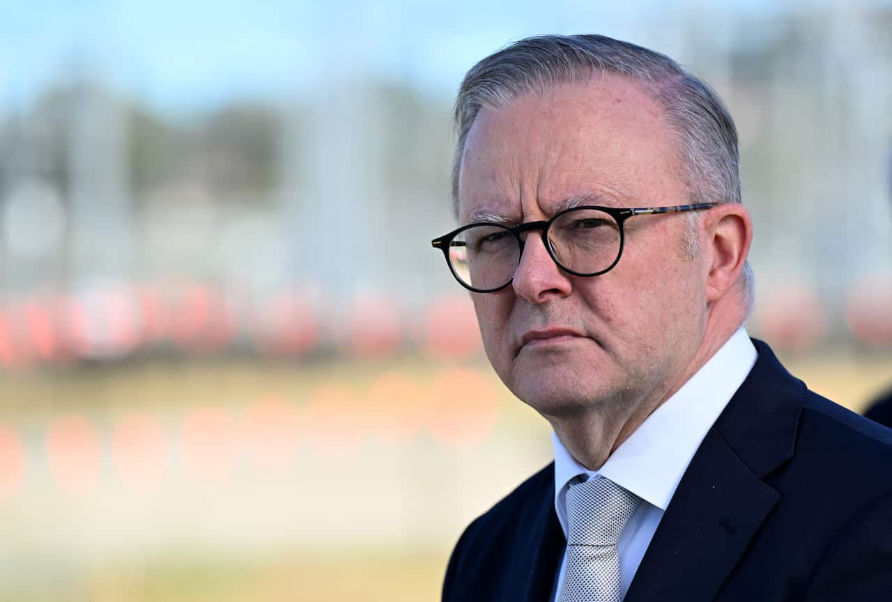 Anthony Albanese standing in front of a blurred background.