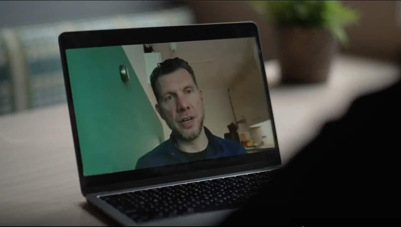 A man on a video call on a laptop.