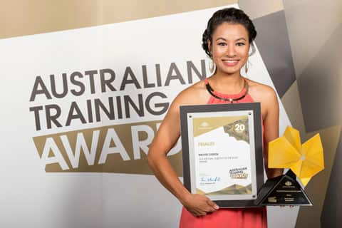 a woman holding an award