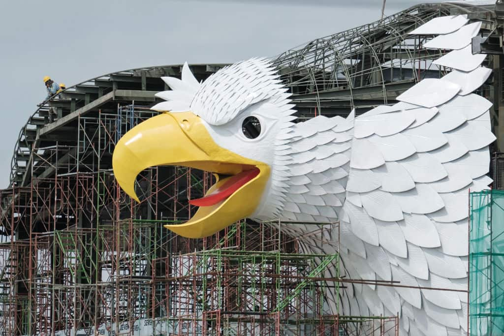 A building with a bird of prey (well, technically a Garuda, but close enough) motif under construction