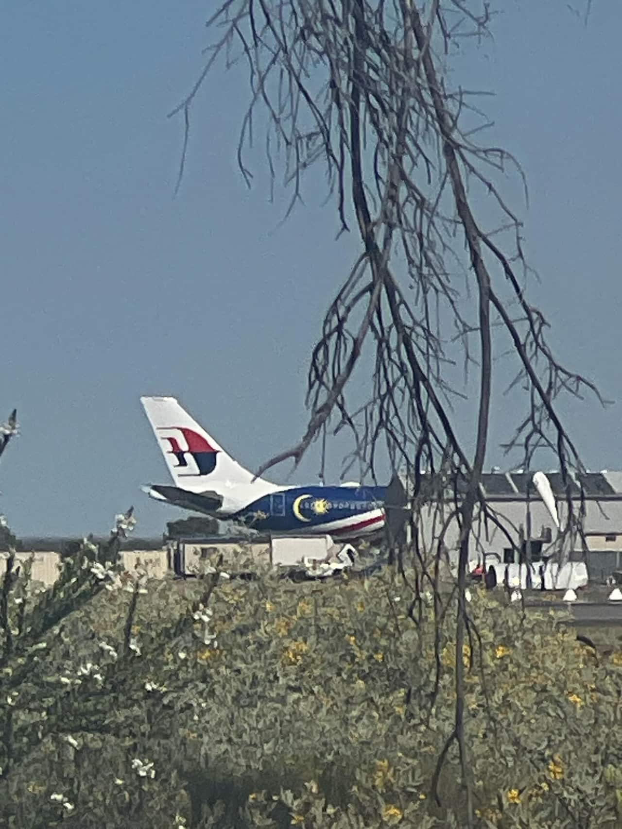 A Malaysia Airlines plane parked on the tarmac.