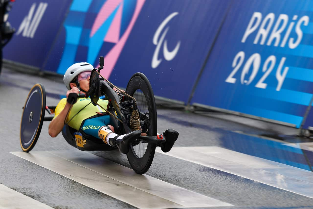 A woman competes in a para-cycling race. 