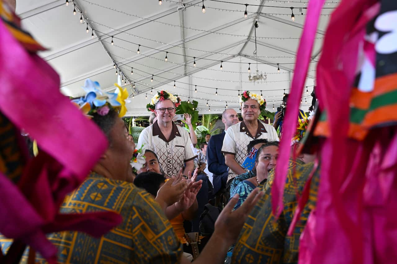 Anthony Albanese (left) and Tuvaluan Prime Minister Feleti Teo (right) stand in the centre of colourful celebrations.