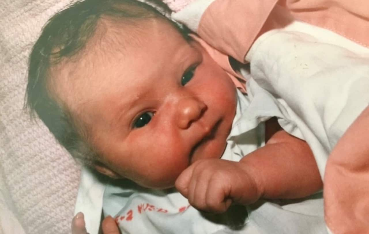 A newborn baby with brown hair