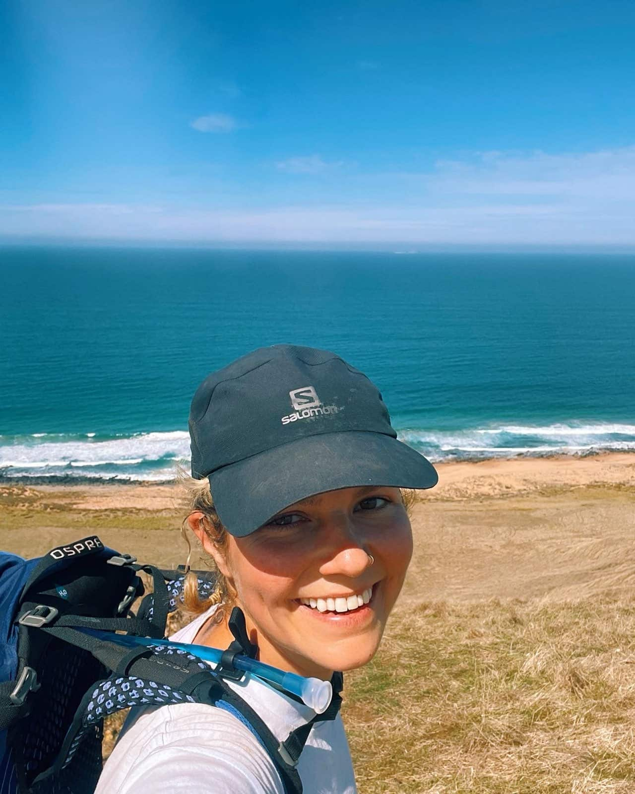 A woman in a cap near a beach