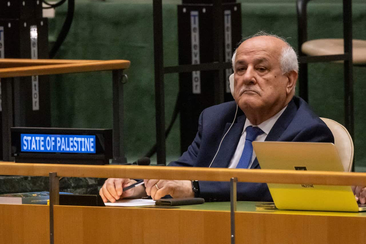 Riyad Mansour sitting at a bench at the UN General Assembly. 