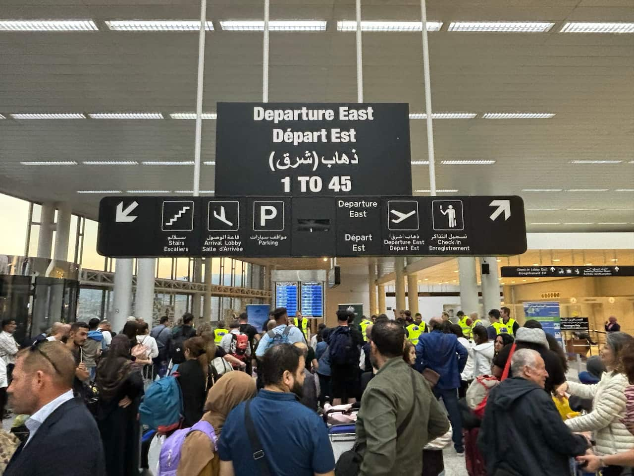 A group of people at an airport departure gate