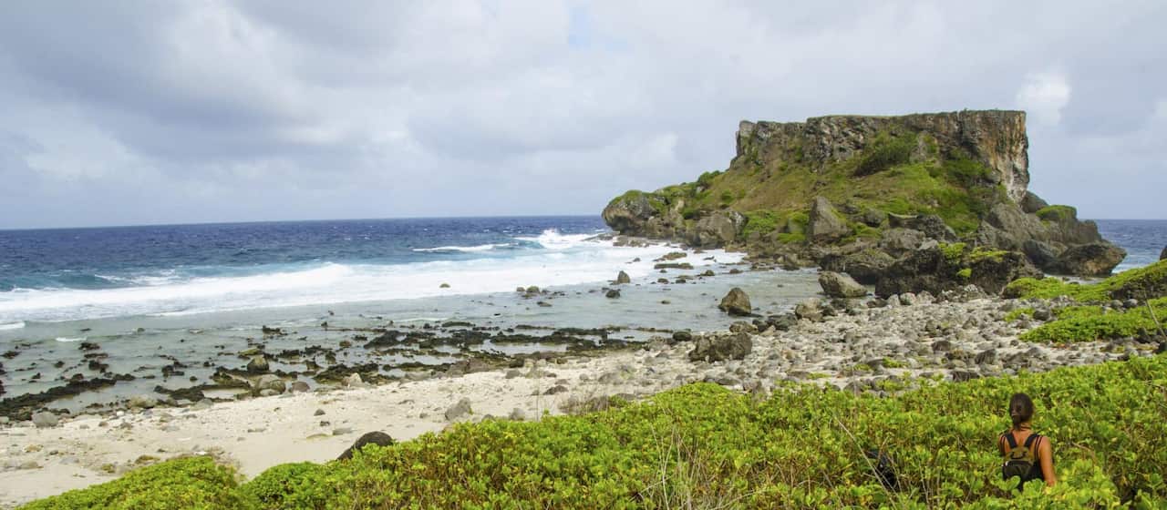 A beach and rocky post of an island.