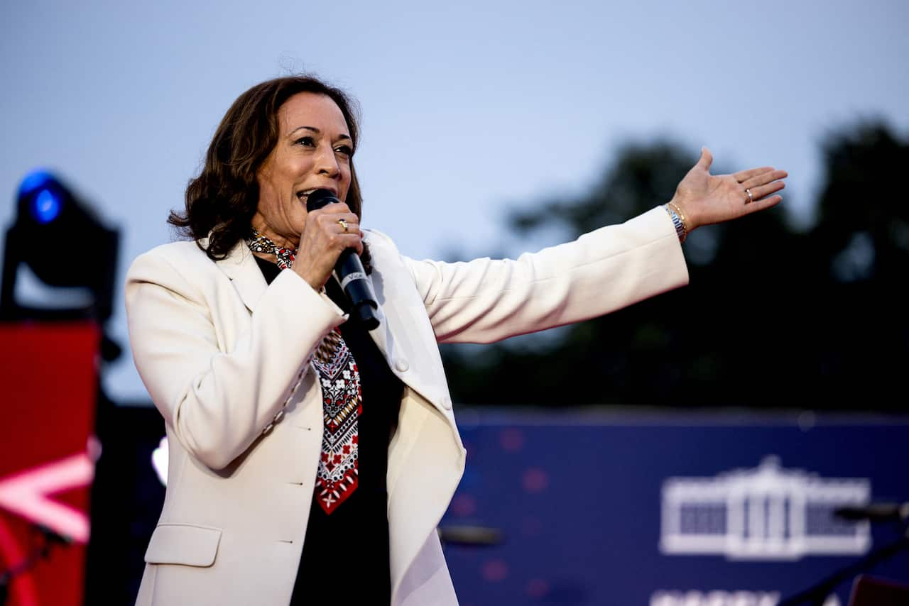 Kamala Harris holding a microphone.