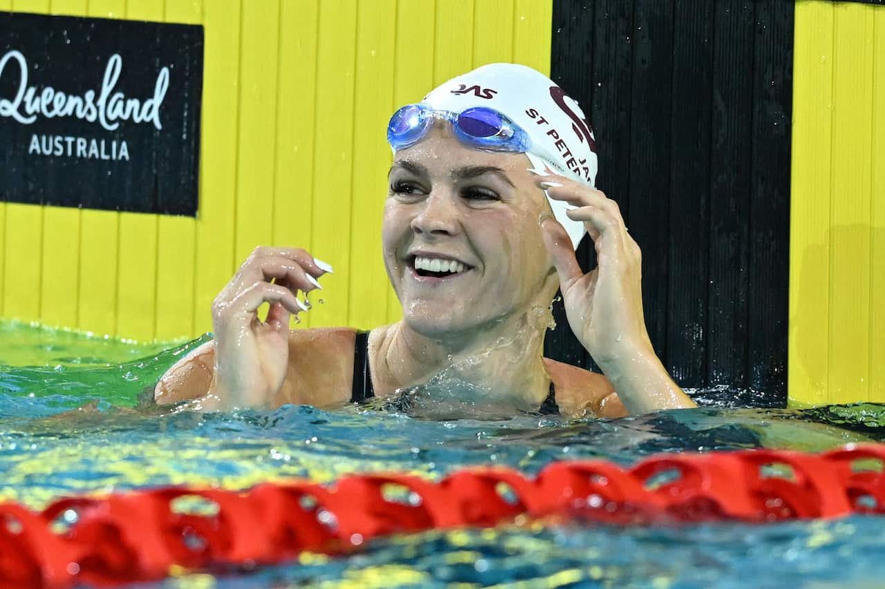 Shayna Jack smiling in a swimming pool after a race.