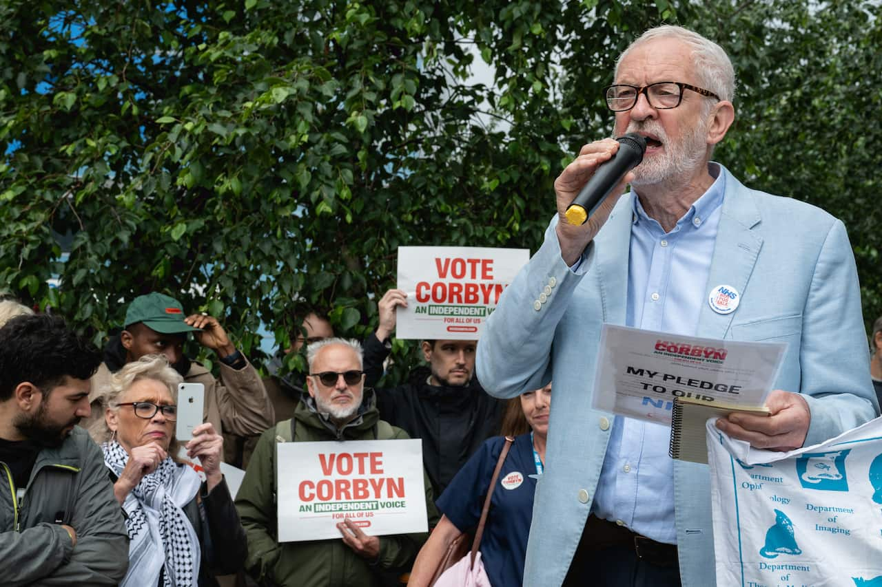 Jeremy Corbyn speaks into a microphone at a campaign rally.