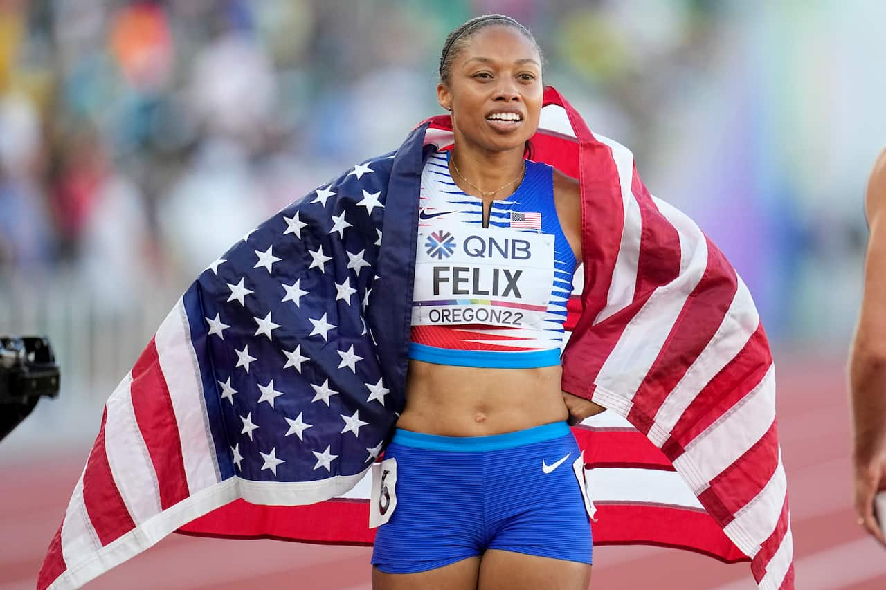 Allyson Felix with a USA flag after a race