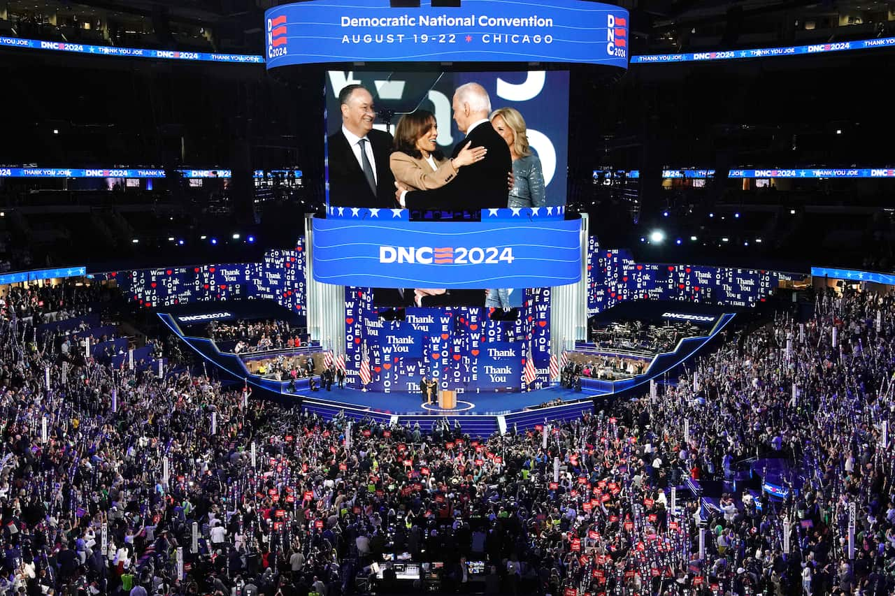 Kamala Harris greeting President Joe Biden as First Lady Jill Biden and Second Gentleman Doug Emhoff look on at the Democratic National Convention. 