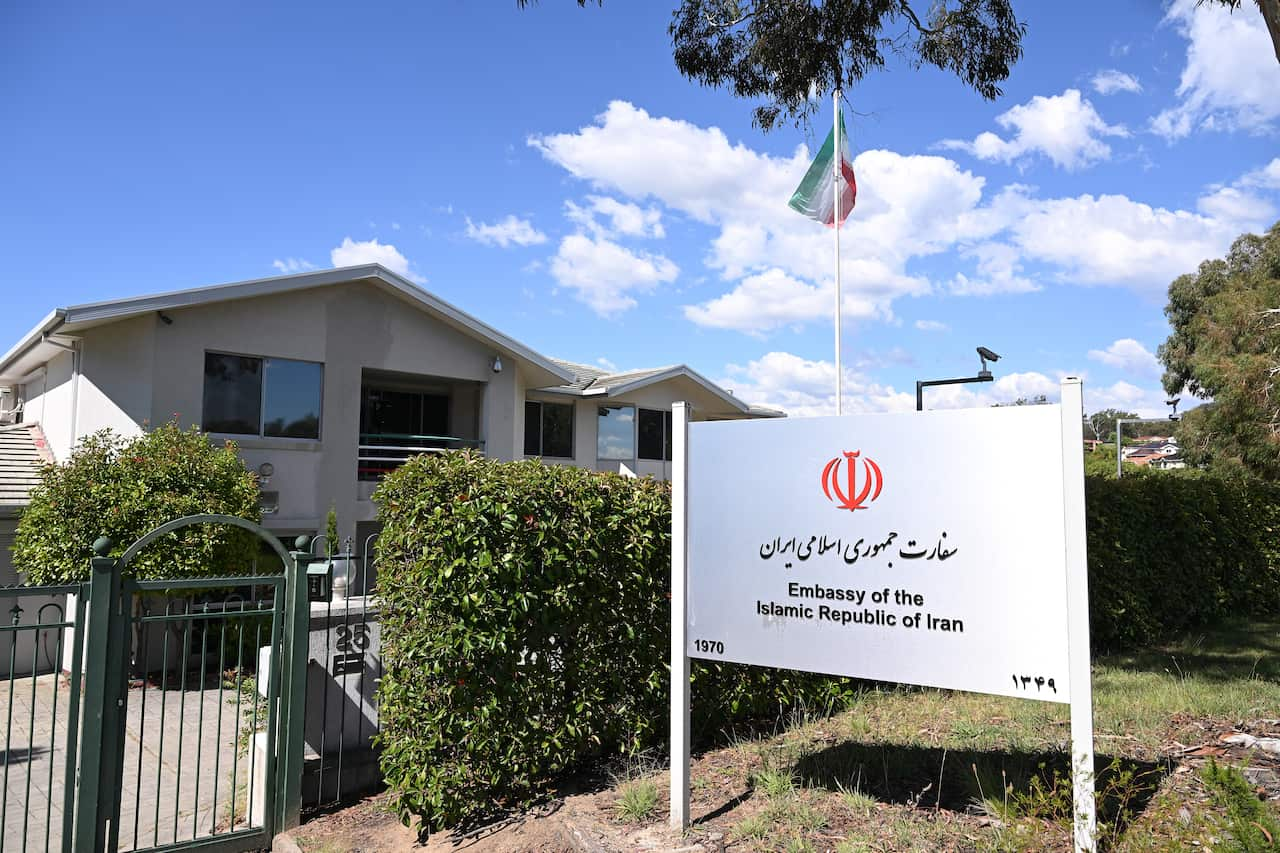 An embassy building with Iranian flag flying in front