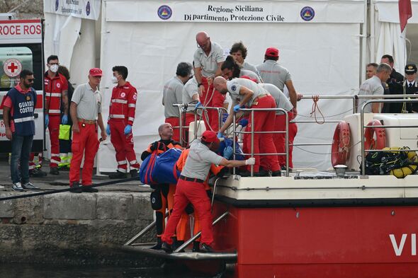 The body of a fifth victim is brought on shore