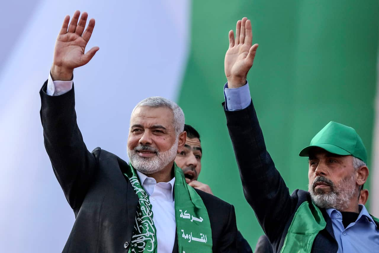 Yahya Al-Sinwar and late Hamas leader Ismail Haniyeh wave to crowd