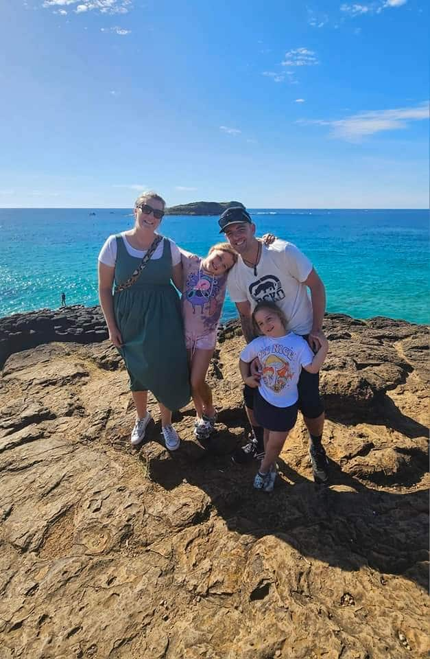 a family standing on a cliff