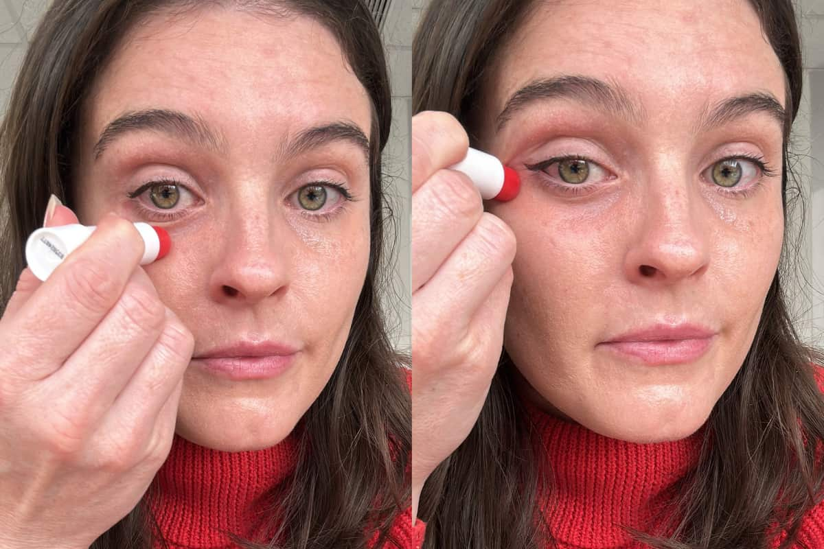 A woman in a red jumper applying eye cream