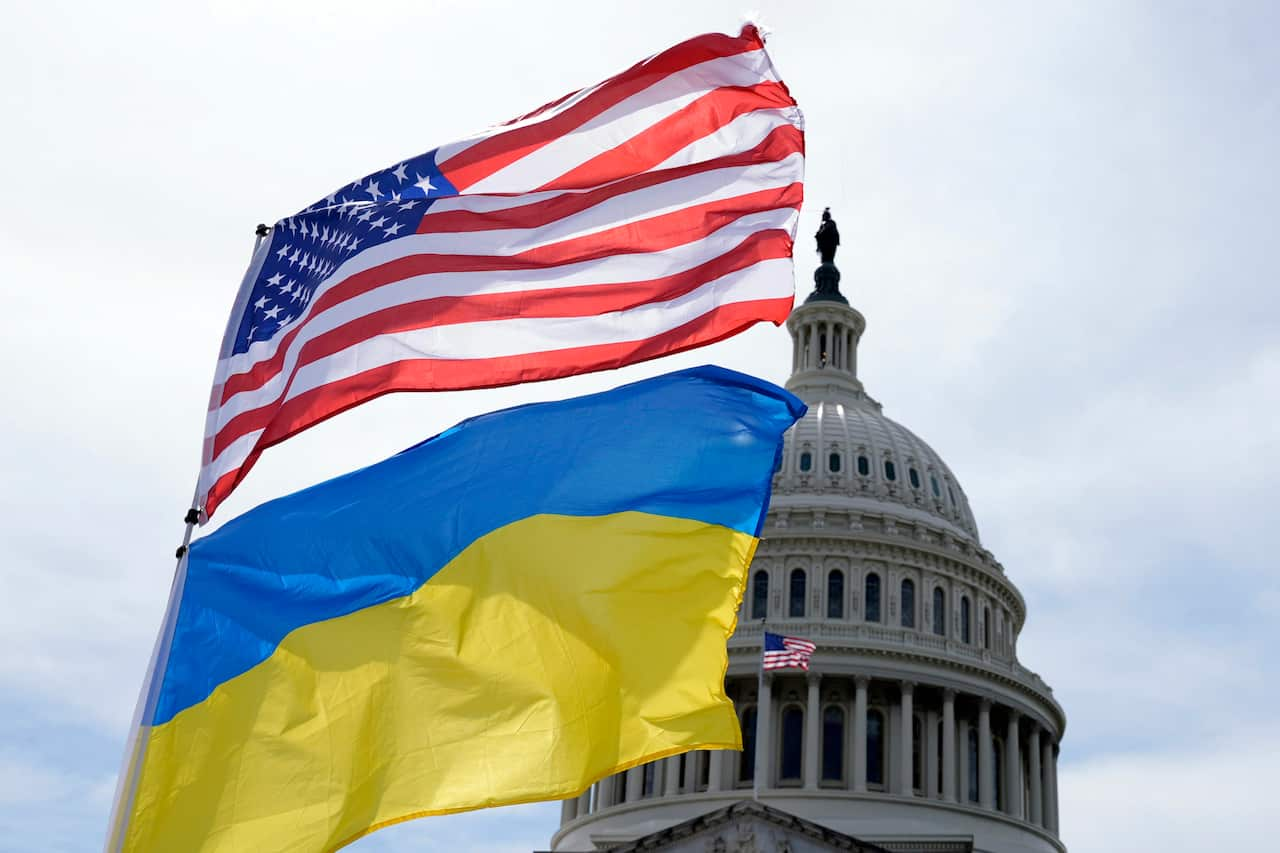 The American and Ukrainian flags in front of a building