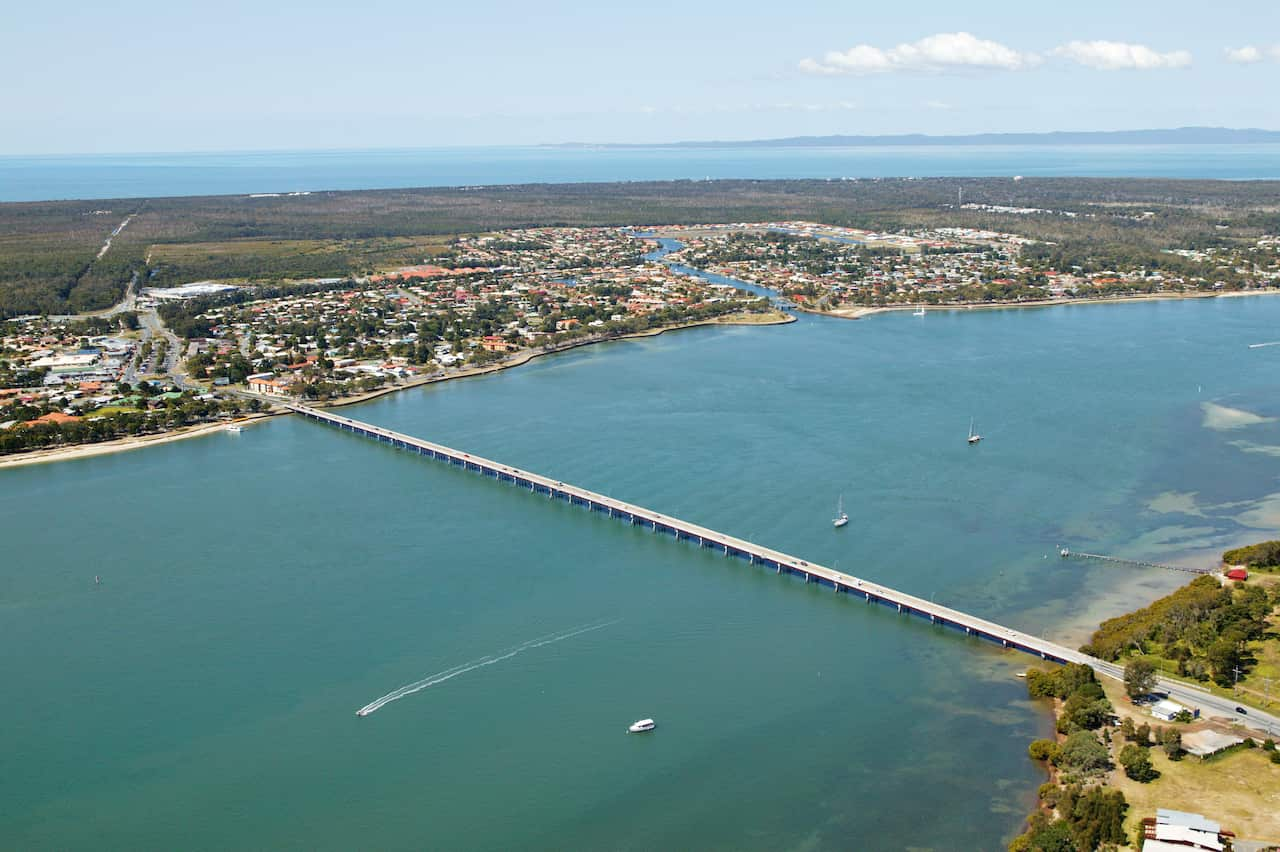 Aerial view of a settlement on an island and bridge.