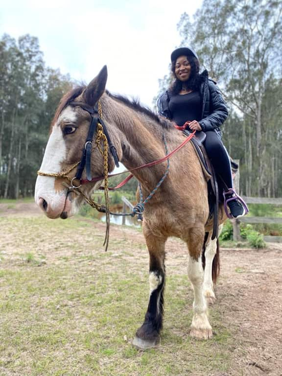 A woman riding a horse.