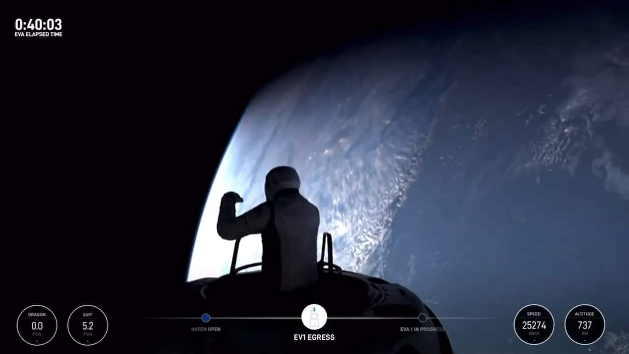 A person silhouetted emerging from a spacecraft, with a large blue planet below them.