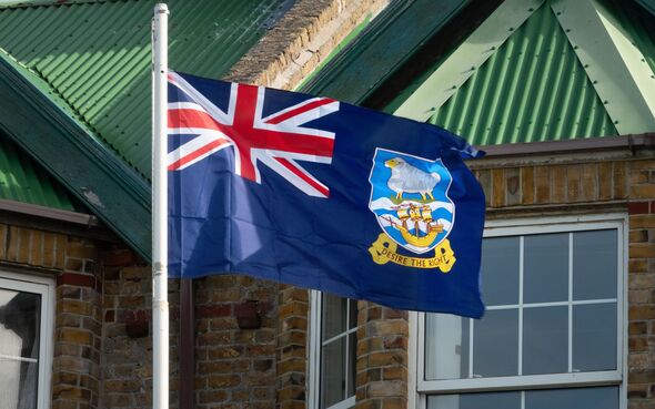 The Falkland Islands flag on a pole in Stanley harbor, Falkland Islands (Islas Malvinas), UK