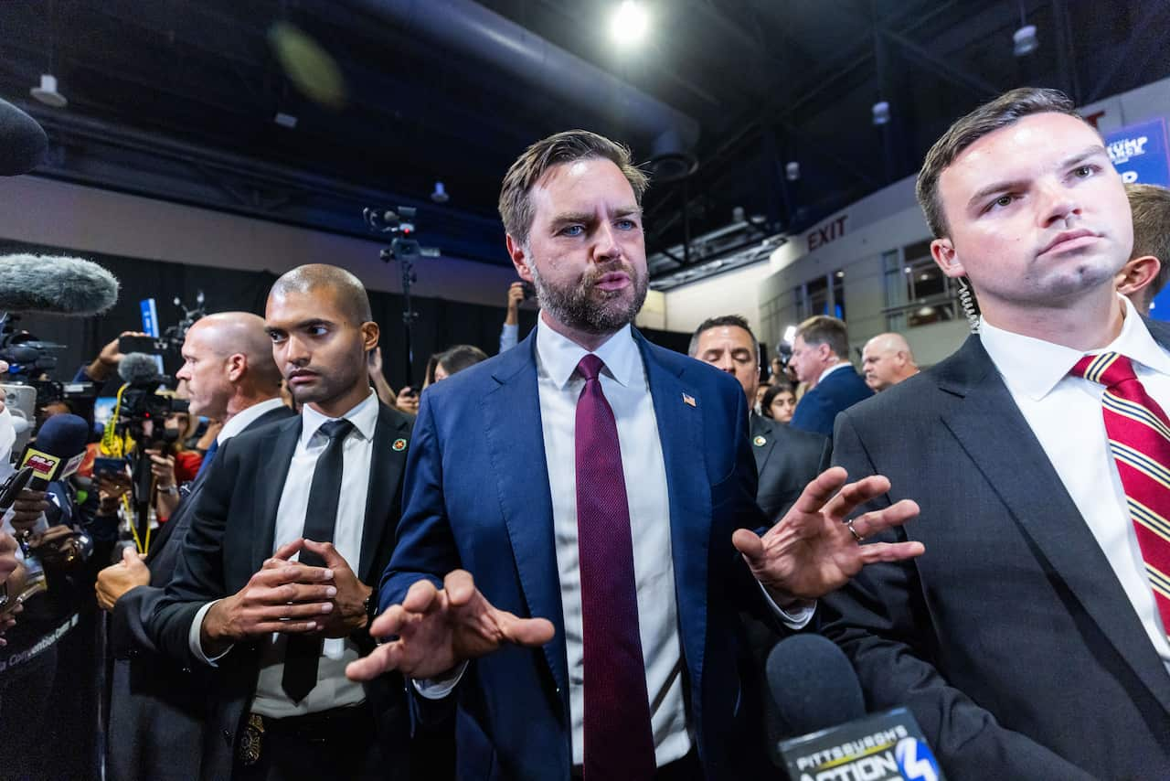 JD Vance speaking to journalists.