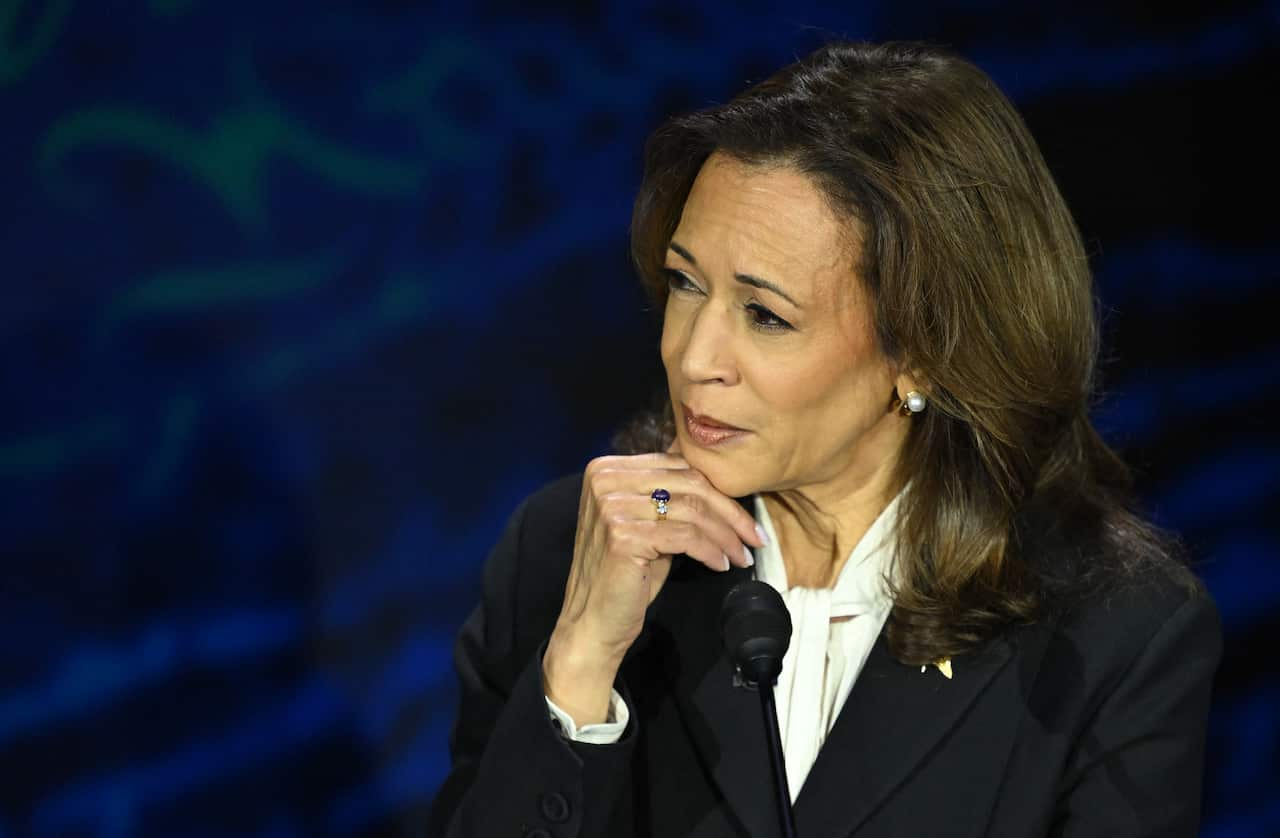 Kamala Harris listens as Donald Trump speaks.