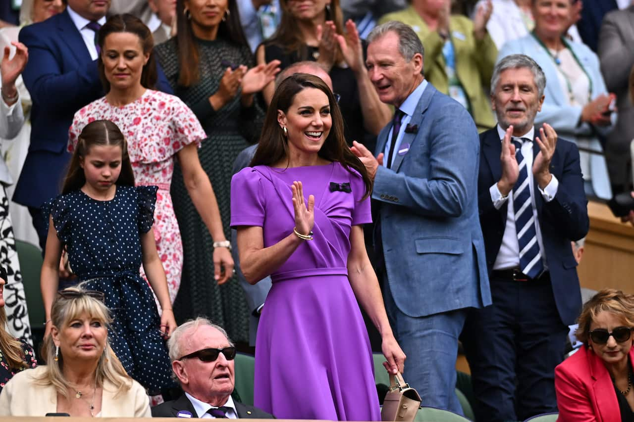 Princess Kate is with her daughter among a group of people.