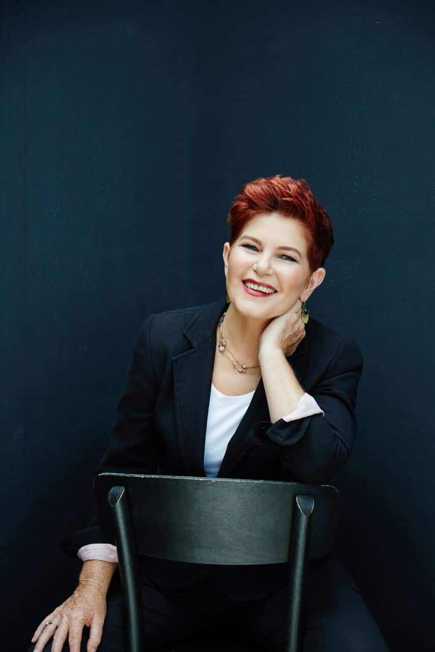 A woman sitting on a chair smiling 