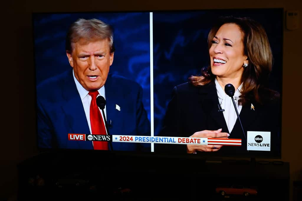 Donald Trump and Kamala Harris on a tv screen