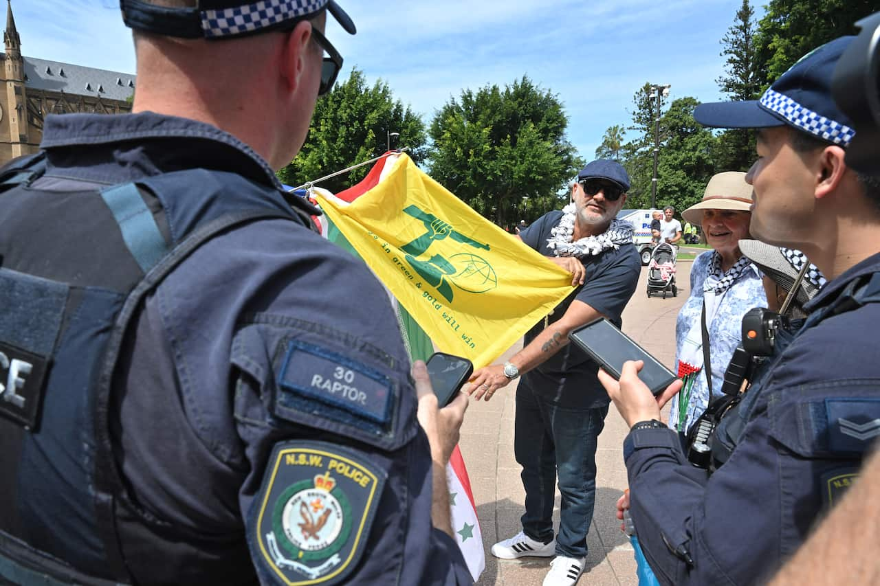 Police holding up a green and yellow flag