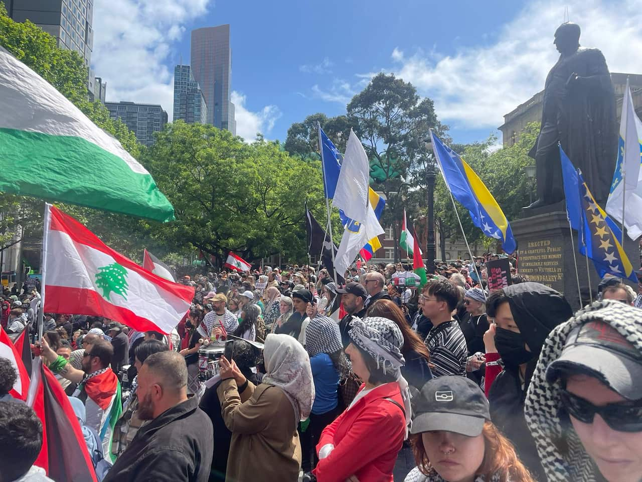 A crowd of people waving flags