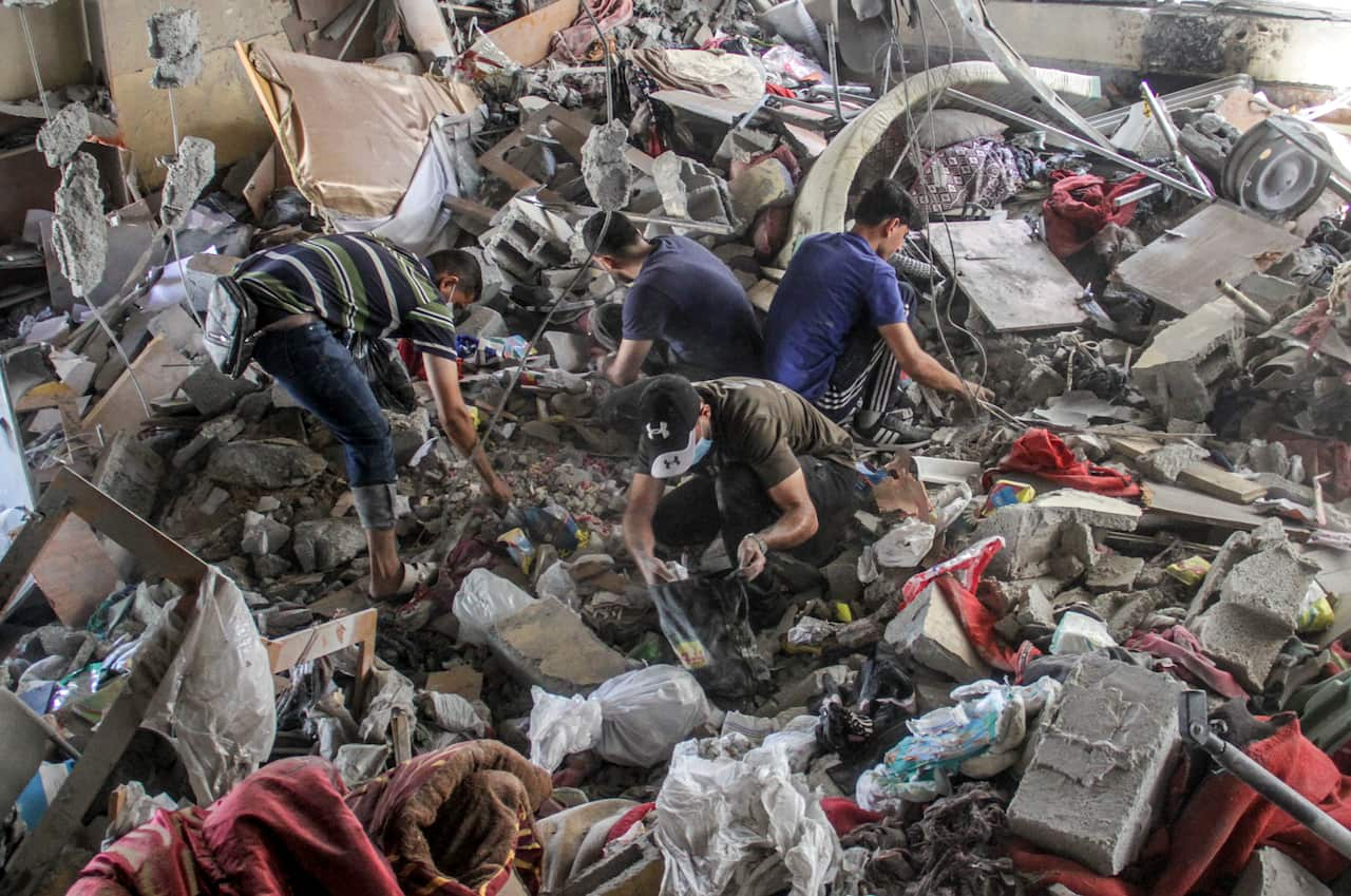 Men searching through rubble and debris.