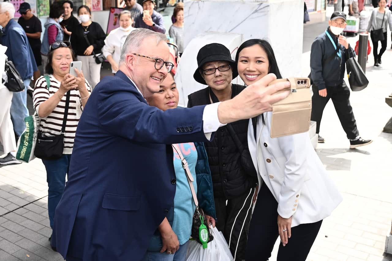 Anthony Albanese takes a selfie with members of the Asian community.